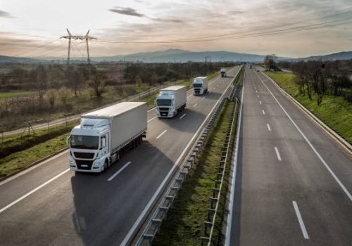 Caravan or convoy of trucks in line on a country highway